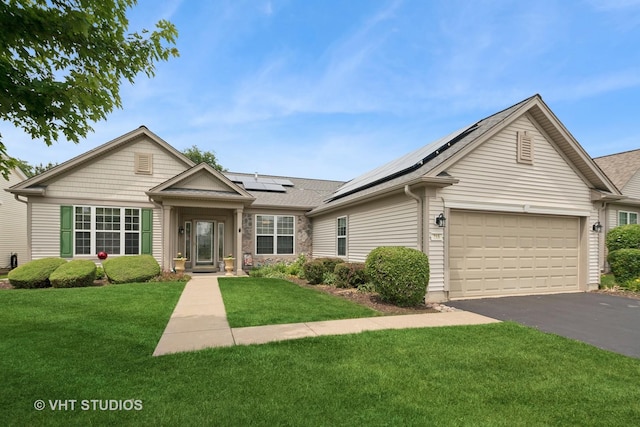 319 Capital Dr, Shorewood, IL 60404 - single story home featuring asphalt driveway, a garage, a front lawn, solar panels, and a shingled roof