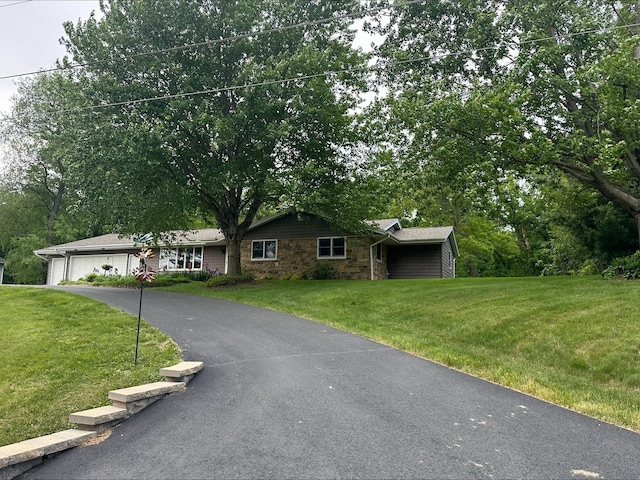13075 Pleasant St, Morrison, IL 61270 - ranch-style home with stone siding, a front yard, and driveway