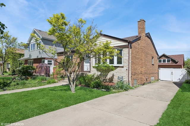 1225 Morgan Ave, La Grange Park, IL 60526 - view of front of house featuring a gate, a chimney, and brick siding