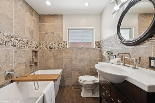 1225 Morgan Ave, La Grange Park, IL 60526 - bathroom with tile walls, toilet, a bath, vanity, and wood finished floors