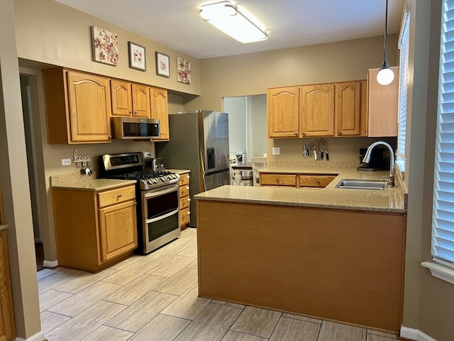 7 Ivy Ct, South Elgin, IL 60177 - kitchen with appliances with stainless steel finishes, a peninsula, wood finish floors, pendant lighting, and light stone counters