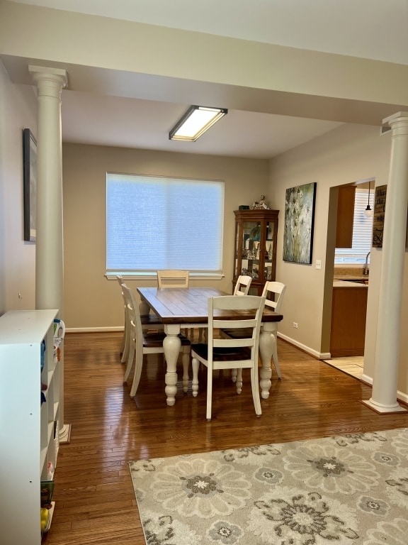 7 Ivy Ct, South Elgin, IL 60177 - dining room featuring ornate columns, wood finished floors, and plenty of natural light