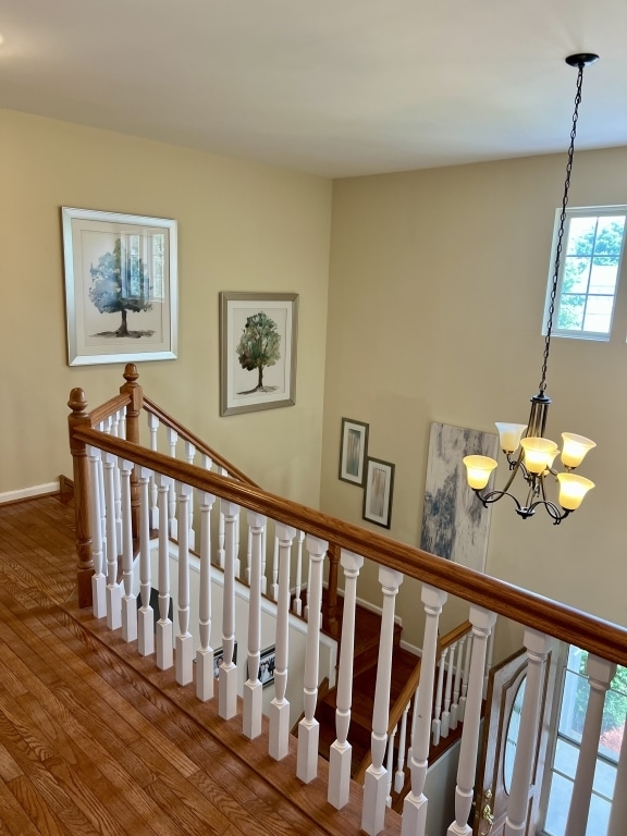 7 Ivy Ct, South Elgin, IL 60177 - stairway with wood finished floors and a chandelier
