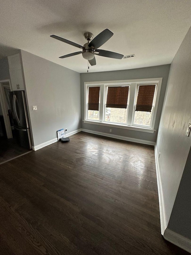 2009 W Garfield Blvd, Chicago, IL 60636 - unfurnished room with dark wood-style flooring, baseboards, a ceiling fan, and a textured ceiling
