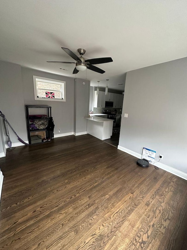 2009 W Garfield Blvd, Chicago, IL 60636 - unfurnished living room featuring dark wood-type flooring, a ceiling fan, and baseboards
