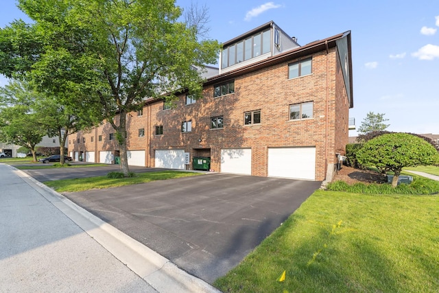 15715 Deerfield Ct Unit 1S, Orland Park, IL 60462 - view of building exterior with an attached garage and driveway