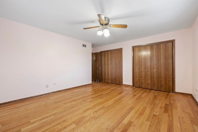 8862 167th St, Orland Hills, IL 60487 - unfurnished bedroom featuring multiple closets, light wood-style floors, baseboards, and ceiling fan