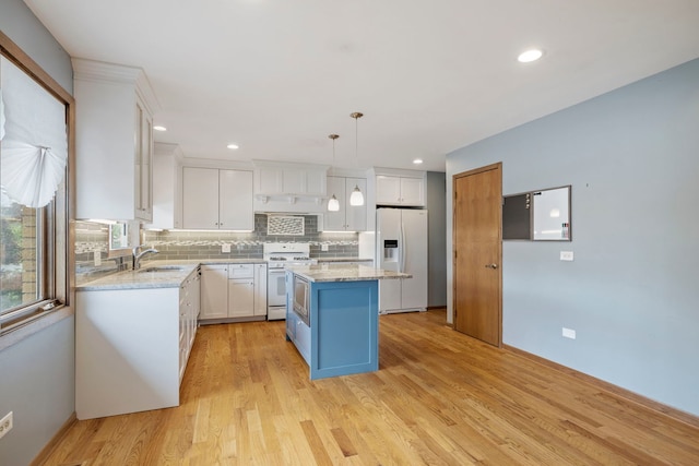 8862 167th St, Orland Hills, IL 60487 - kitchen with white appliances, white cabinetry, backsplash, light wood-style floors, and a center island