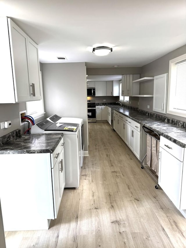 2407 Burbank St, Joliet, IL 60435 - kitchen with appliances with stainless steel finishes, open shelves, dark countertops, and light wood-style floors