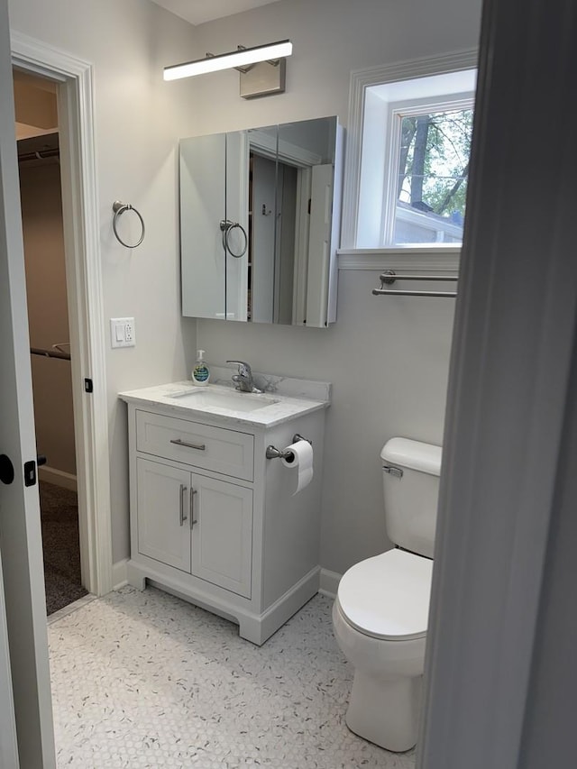 2407 Burbank St, Joliet, IL 60435 - half bath with vanity, baseboards, and toilet