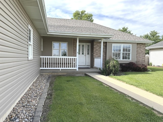 350 Centerpoint Dr N, Bourbonnais, IL 60914 - view of front of property with brick siding, a porch, a shingled roof, and a front lawn