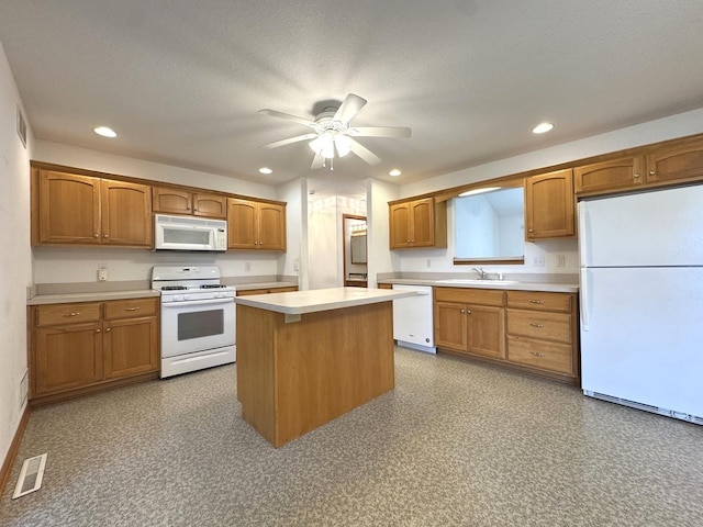 350 Centerpoint Dr N, Bourbonnais, IL 60914 - kitchen with white appliances, light countertops, a sink, ceiling fan, and a center island