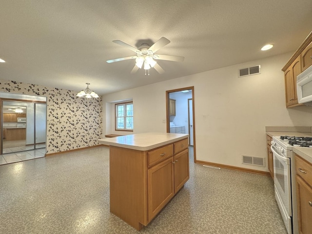 350 Centerpoint Dr N, Bourbonnais, IL 60914 - kitchen with white appliances, baseboards, light countertops, ceiling fan, and a chandelier