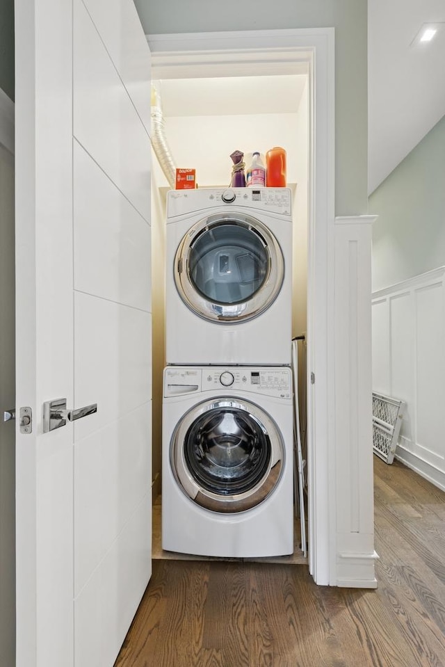 1110 N Marshfield Ave Unit 2, Chicago, IL 60622 - washroom with stacked washer and clothes dryer, wood finished floors, a wainscoted wall, and a decorative wall