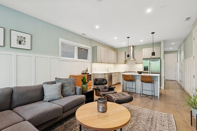 1110 N Marshfield Ave Unit 2, Chicago, IL 60622 - living room with a decorative wall, light wood finished floors, wainscoting, and recessed lighting