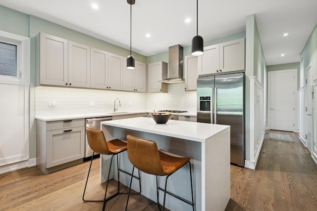 1110 N Marshfield Ave Unit 2, Chicago, IL 60622 - kitchen with appliances with stainless steel finishes, wall chimney range hood, tasteful backsplash, a kitchen island, and light countertops
