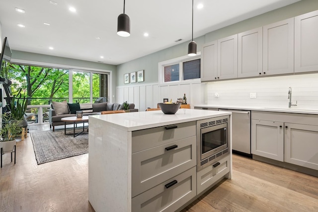 1110 N Marshfield Ave Unit 2, Chicago, IL 60622 - kitchen with stainless steel microwave, a sink, gray cabinets, dishwasher, and light countertops
