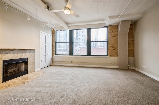 411 W Ontario St Unit 623, Chicago, IL 60654 - unfurnished living room with rail lighting, carpet, a premium fireplace, a ceiling fan, and baseboards