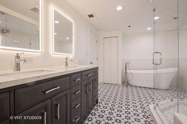 411 W Ontario St Unit 623, Chicago, IL 60654 - full bath with a soaking tub, tile patterned floors, double vanity, a stall shower, and recessed lighting