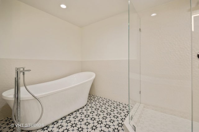 411 W Ontario St Unit 623, Chicago, IL 60654 - bathroom featuring tiled shower, a freestanding bath, tile patterned floors, and recessed lighting