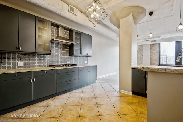 411 W Ontario St Unit 623, Chicago, IL 60654 - kitchen featuring wall chimney range hood, tasteful backsplash, baseboards, a tray ceiling, and light tile patterned flooring