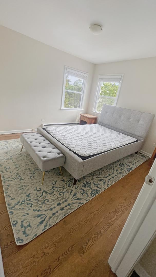 39 W Conti Pkwy Unit 2N, Elmwood Park, IL 60707 - bedroom featuring wood finished floors and baseboards