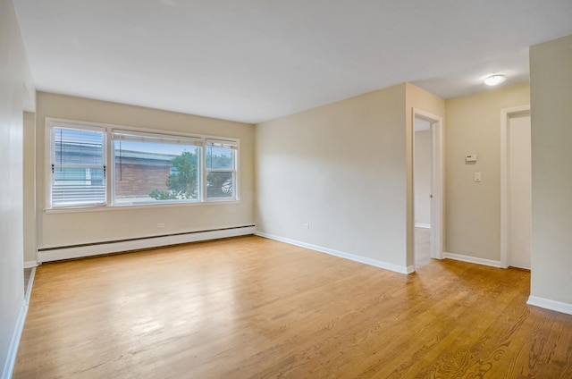 39 W Conti Pkwy Unit 2N, Elmwood Park, IL 60707 - unfurnished room featuring baseboard heating, wood finished floors, and baseboards