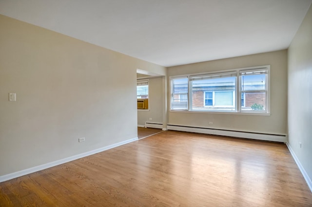 39 W Conti Pkwy Unit 2N, Elmwood Park, IL 60707 - empty room with a baseboard heating unit, wood finished floors, baseboards, and cooling unit