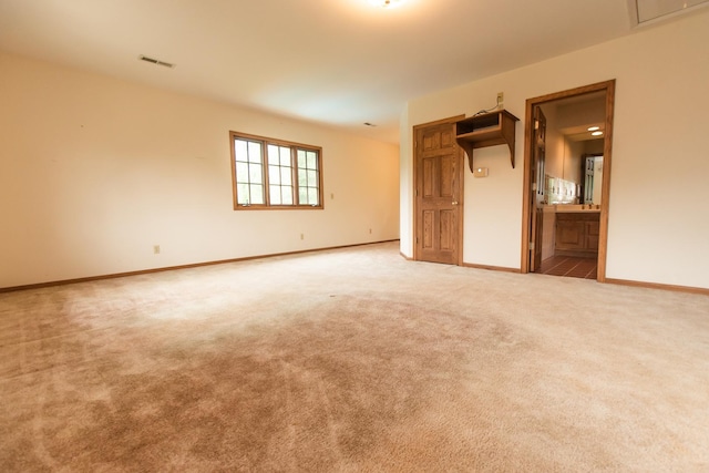 1131 Fourth Ave, Dixon, IL 61021 - unfurnished bedroom featuring carpet floors, baseboards, connected bathroom, and attic access