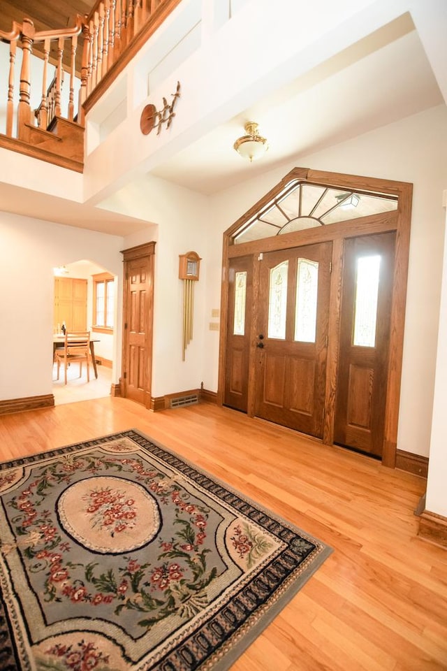1131 Fourth Ave, Dixon, IL 61021 - foyer with arched walkways, wood finished floors, plenty of natural light, and a high ceiling