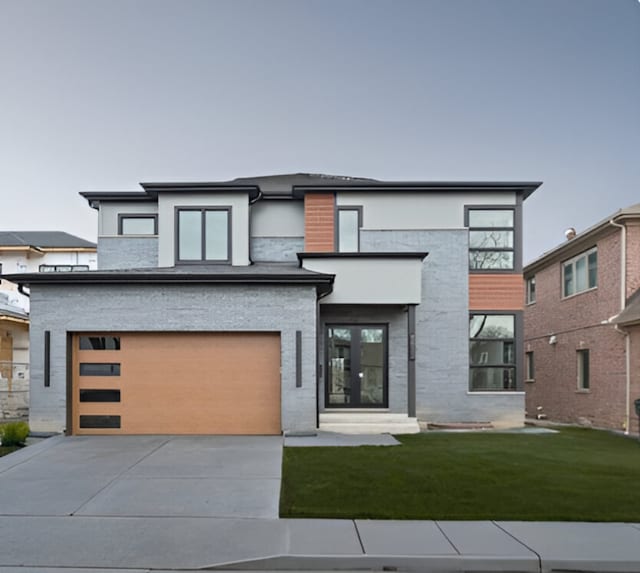 8833 Birch Ave, Morton Grove, IL 60053 - modern home featuring concrete driveway, an attached garage, a front lawn, stucco siding, and stone siding