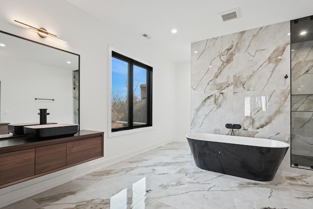 8833 Birch Ave, Morton Grove, IL 60053 - bathroom with a freestanding tub, vanity, recessed lighting, marble finish flooring, and a marble finish shower