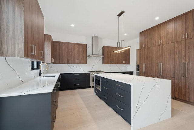 8833 Birch Ave, Morton Grove, IL 60053 - kitchen featuring wall chimney range hood, a sink, stainless steel stove, a kitchen island, and light stone countertops