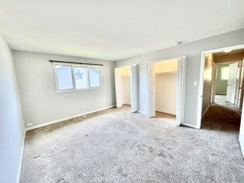 807 Violet Ln, Matteson, IL 60443 - unfurnished bedroom with multiple closets, carpet flooring, and baseboards