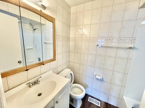 807 Violet Ln, Matteson, IL 60443 - bathroom with vanity, toilet, a shower, tile walls, and a bath