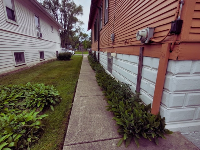 318 W 112th St, Chicago, IL 60628 - view of side of property featuring cooling unit and a yard