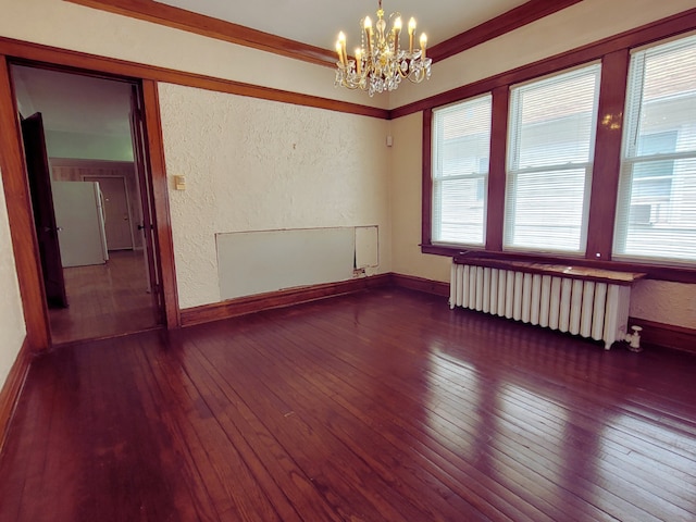318 W 112th St, Chicago, IL 60628 - unfurnished room featuring radiator, a textured wall, plenty of natural light, hardwood / wood-style flooring, and a chandelier