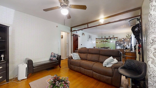 213 Arcadia Dr, Champaign, IL 61820 - living room with wood finished floors, a ceiling fan, a dry bar, and wallpapered walls