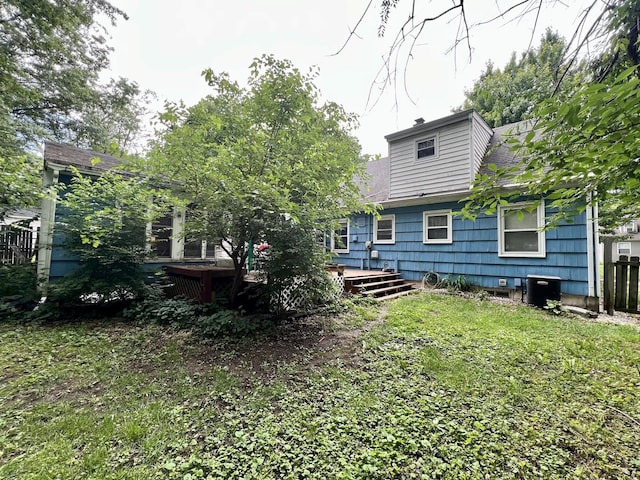 213 Arcadia Dr, Champaign, IL 61820 - back of house featuring a wooden deck and a lawn
