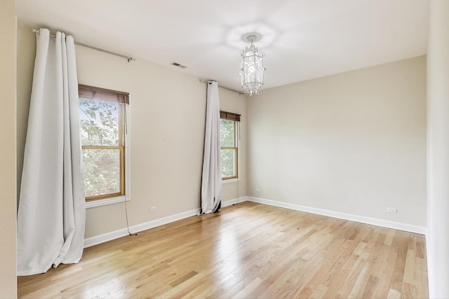 2430 Hastings Ave, Evanston, IL 60201 - empty room with light wood-style flooring and a chandelier