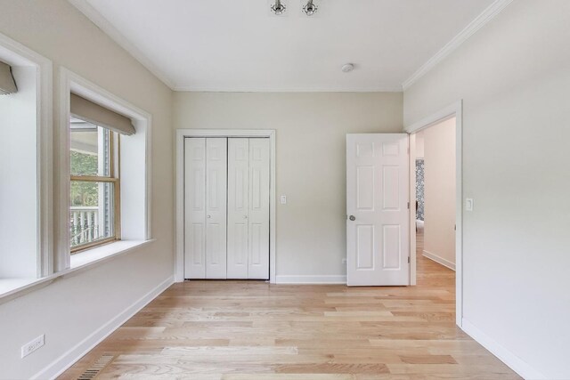 2430 Hastings Ave, Evanston, IL 60201 - unfurnished bedroom with light wood finished floors, crown molding, and a closet