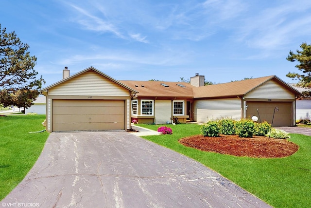 267 Juniper Cir, Streamwood, IL 60107 - ranch-style home featuring a garage, driveway, a front yard, and a chimney