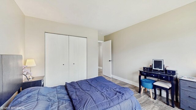 267 Juniper Cir, Streamwood, IL 60107 - bedroom with wood finished floors, a closet, and baseboards