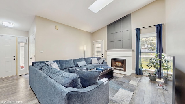 267 Juniper Cir, Streamwood, IL 60107 - living room featuring light wood-style floors, a large fireplace, and high vaulted ceiling