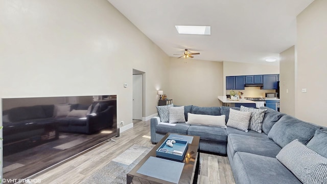267 Juniper Cir, Streamwood, IL 60107 - living area with vaulted ceiling, light wood finished floors, a skylight, ceiling fan, and baseboards