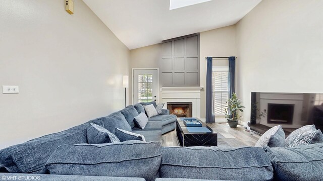 267 Juniper Cir, Streamwood, IL 60107 - living room featuring high vaulted ceiling, a large fireplace, light wood-style flooring, and baseboards