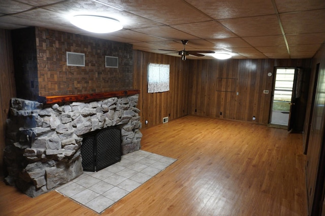 143 W Scott St, Seneca, IL 61360 - living room with light wood finished floors, ceiling fan, healthy amount of natural light, a fireplace, and wooden walls