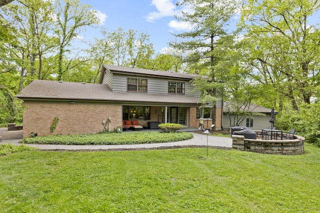 218 Delnor Ave, Saint Charles, IL 60174 - back of house featuring brick siding, a yard, a patio area, and roof with shingles