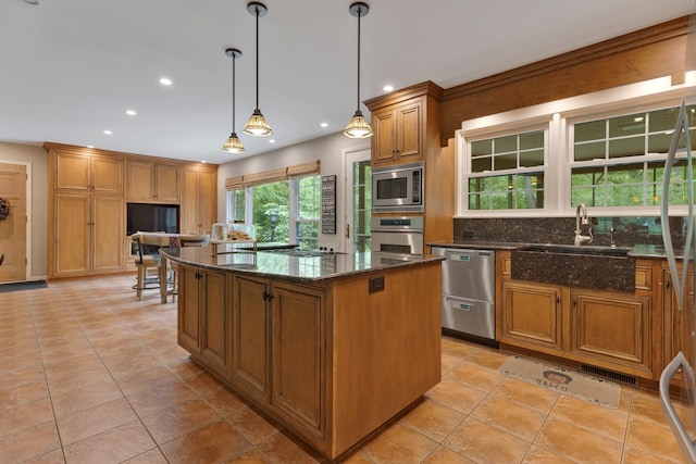 218 Delnor Ave, Saint Charles, IL 60174 - kitchen featuring stainless steel appliances, a sink, a center island, decorative backsplash, and dark stone countertops