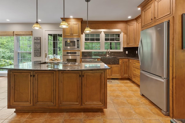 218 Delnor Ave, Saint Charles, IL 60174 - kitchen featuring appliances with stainless steel finishes, a sink, tasteful backsplash, a center island, and dark stone counters